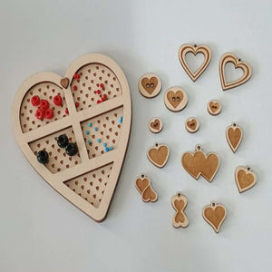 Heart-shaped wooden puzzle with detachable pieces on a light background