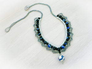 Blue White and Light Green beads from the May Jewel Box kit that make a Necklace with one blue and white porcelain bead