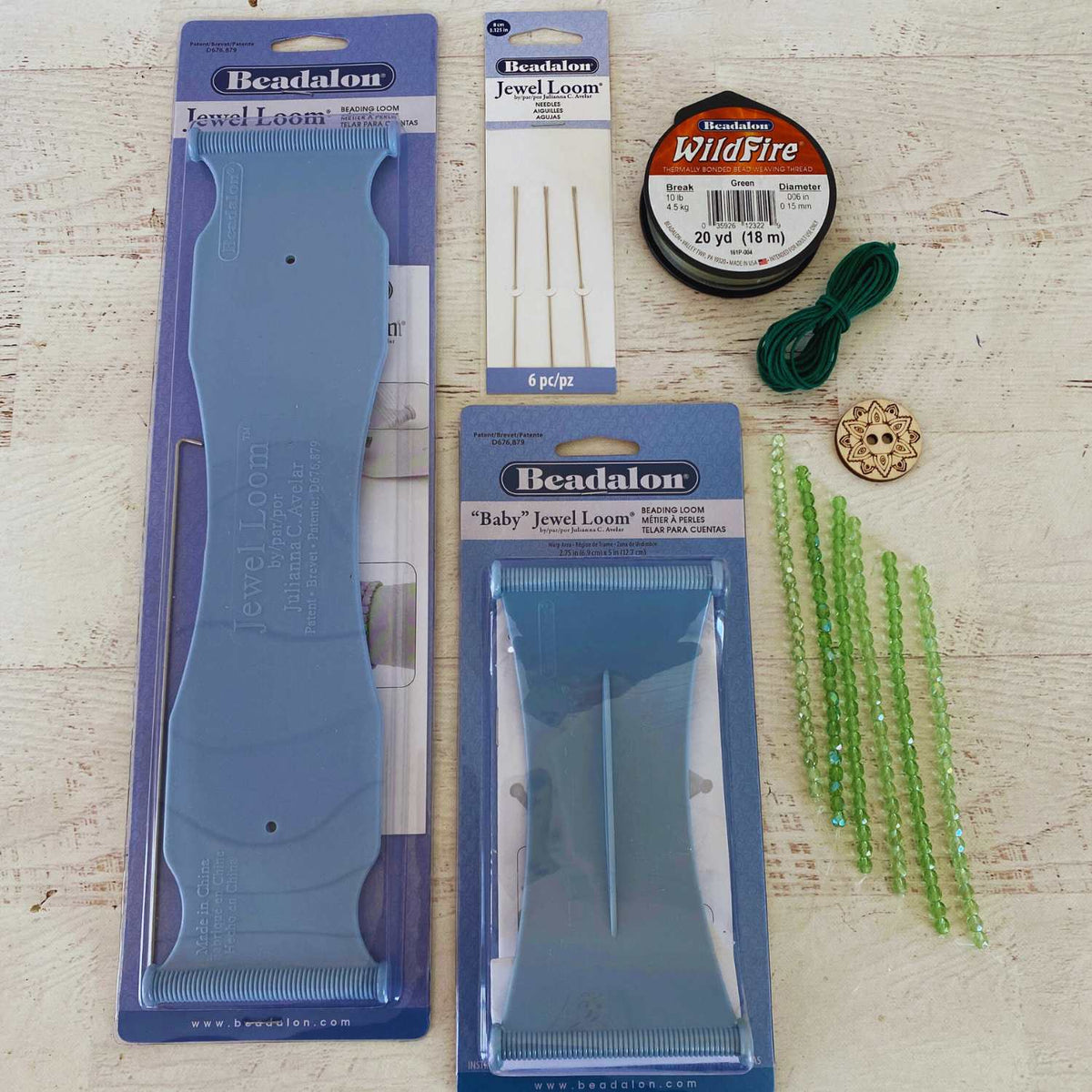 Beadalon jewelry-making tools and materials on a wooden surface