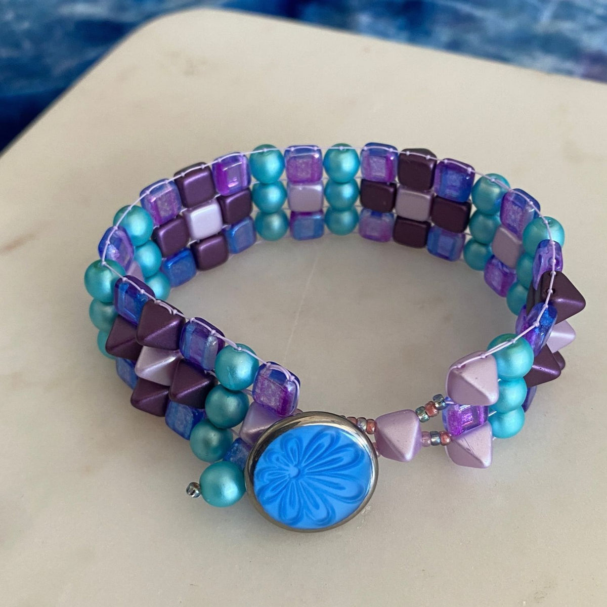 Beaded bracelet made on a bead loom with blues and purples