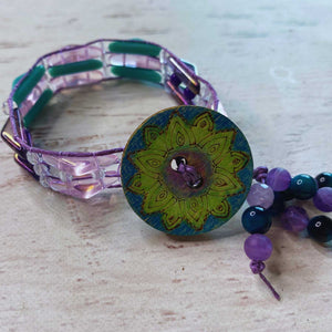 Amethyst Ocean Bead kit Colorful beaded bracelet with a decorative button on a wooden surface