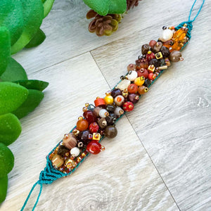 beaded bracelet in a variety of brown earth tone colors with teal warping threads from Beadalon B-Lon