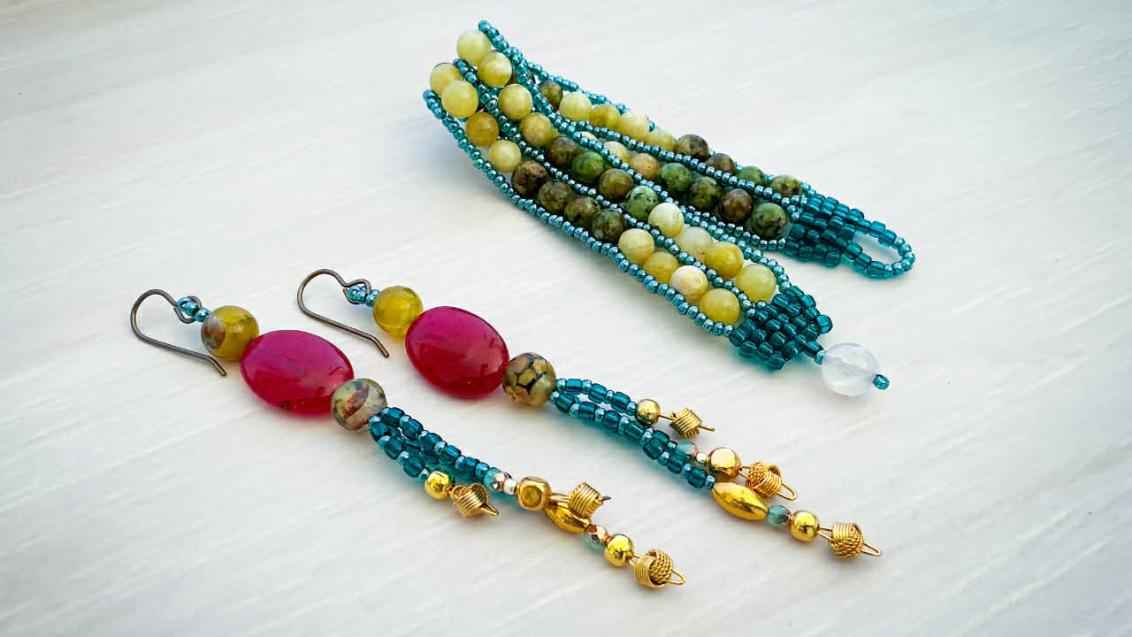 beaded bracelet and earrings from the Jewel Loom Jewel Box April 2026 Kit featuring green yellow and ruby colored gemstones
