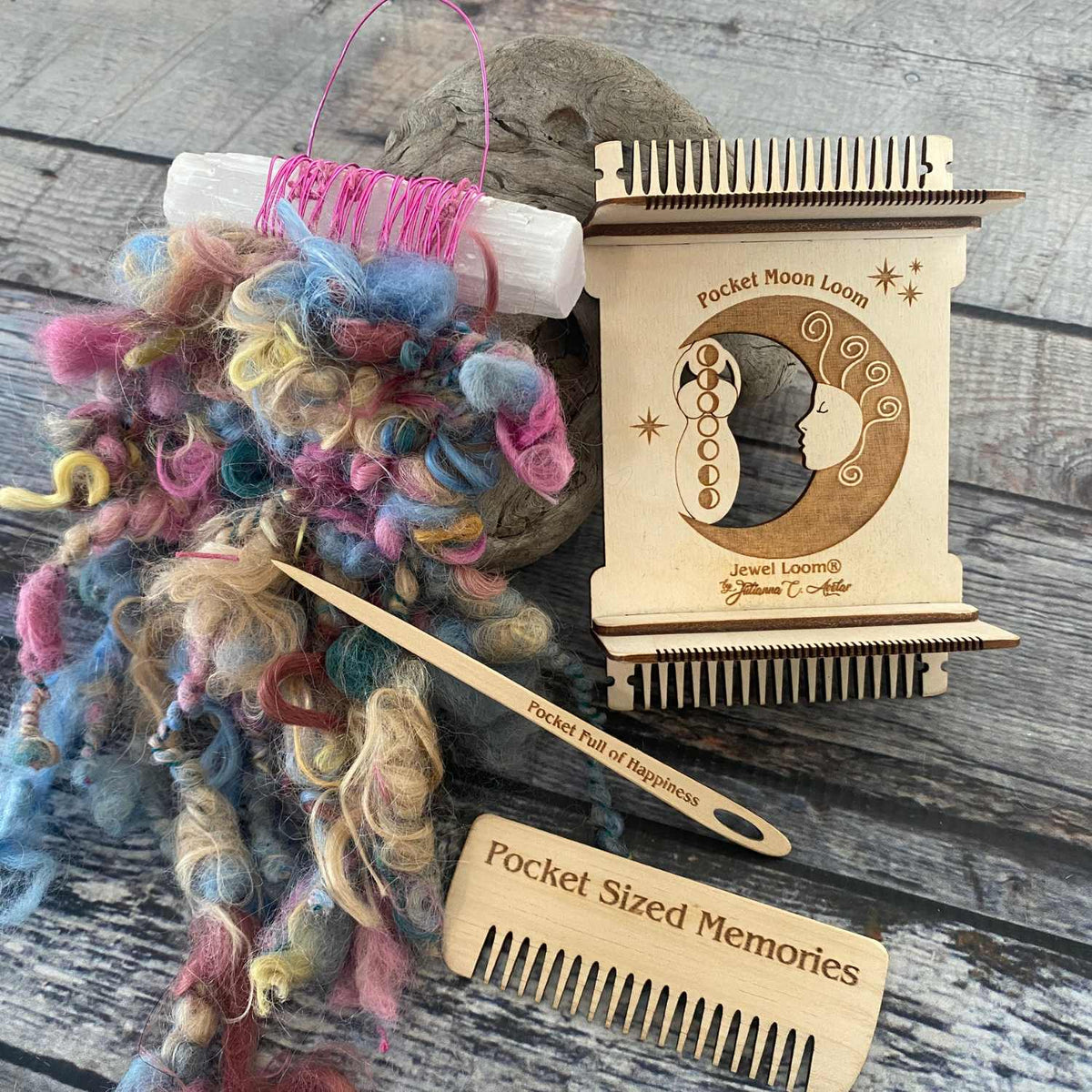 Pocket Moon Loom made of Baltic Birch Wood, comb and needle set with example of Fiber Wall Hanging on medium grey background