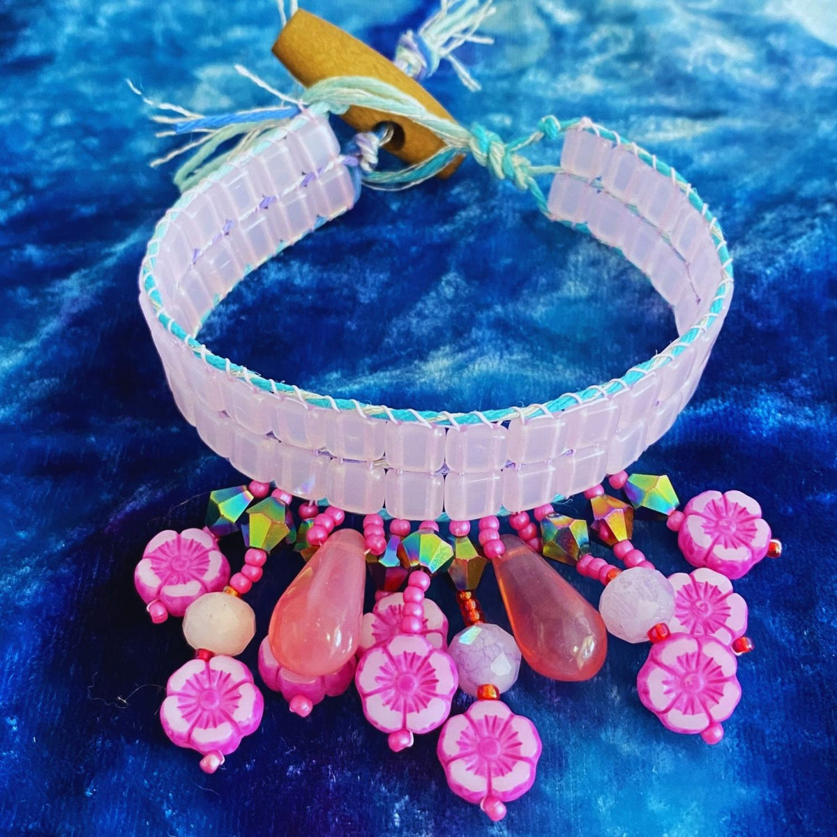 A variety of pink beads that were used to make a beaded bracelet on a bead loom. Hot Pink Hawaiian Flowers and Large Glass beads from the Czech Republic make this bracelet a gorgeous must make. Materials are from the Pretty in Pink Kit  