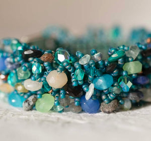 Teal seed bead bracelet with clustered aqua and blue gemstone and crystal beads, made on the Beadalon Jewel Loom by Julianna C. Avelar
